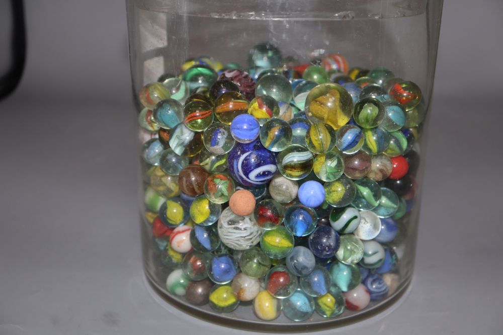 A glass jar and cover containing Victorian and later coloured marbles, height 26.5cm